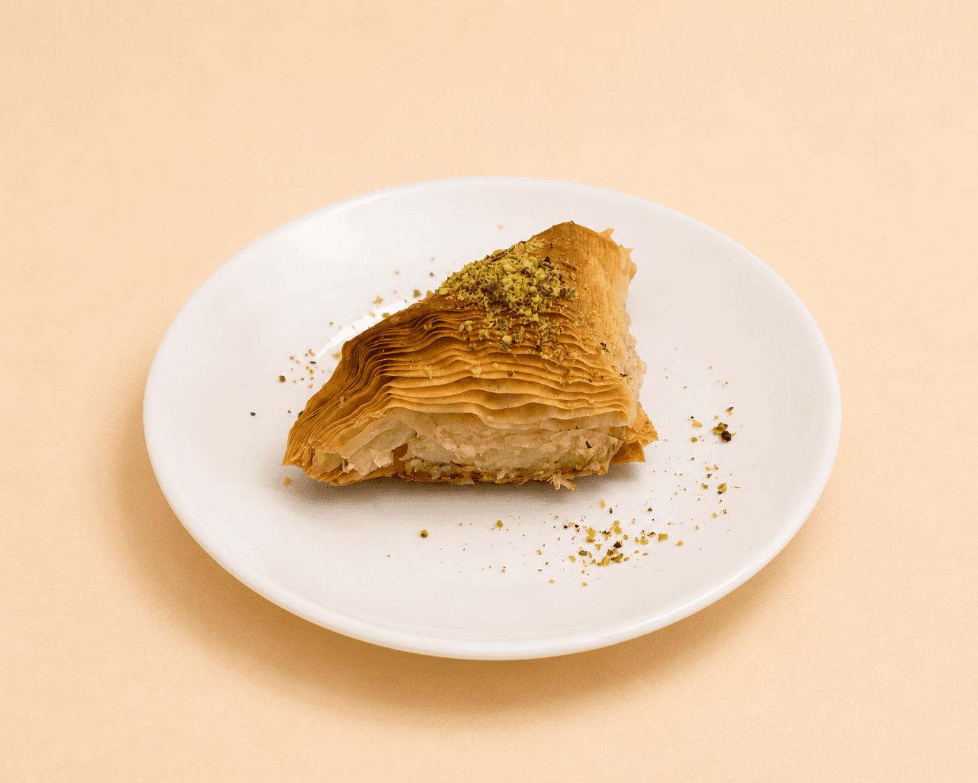 Traditional Lebanese chaabiyat pastries filled with ashta and topped with pistachios